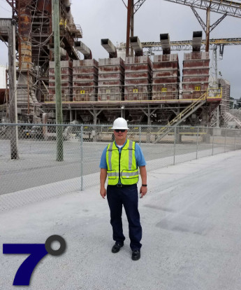 Picture of David Behm standing next to a dust collector.